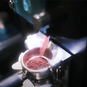 Coffee being ground into a portafilter.