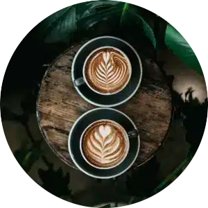 Circular image of a latte and a cappuccino.