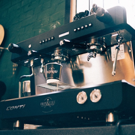 arial view of a flat white coffee on a copper table top