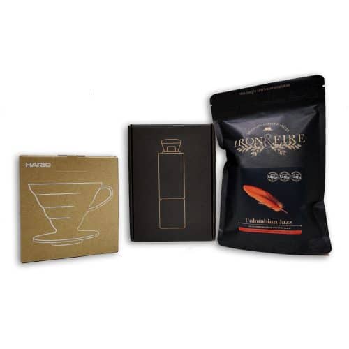 image of a v60 pourover in a box next to a timemore hand grinder in a box and a black bag of coffee.