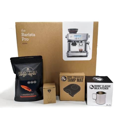 sage coffee machine in a box with milk jug, tamer and tamping mat in their boxes along with a black bag of coffee